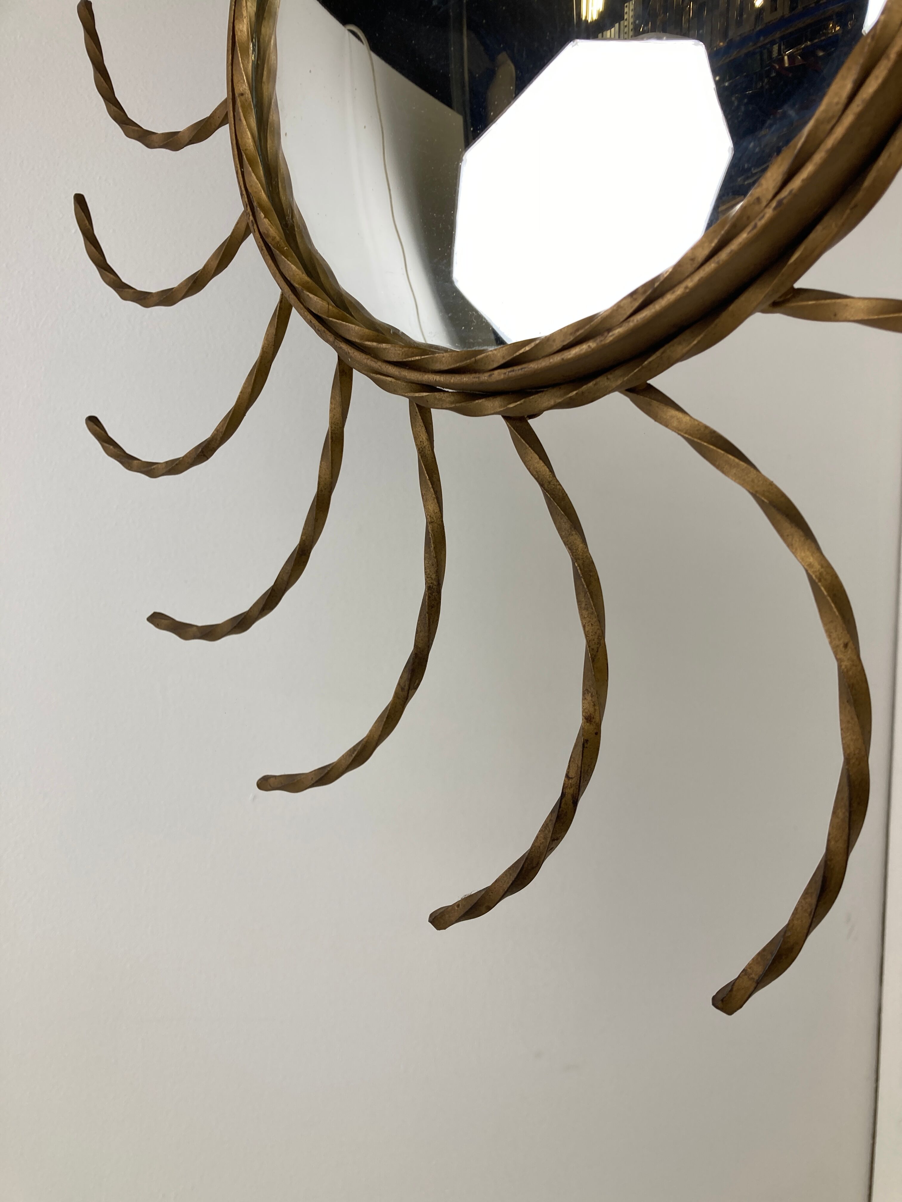 Mid century gold sunburst mirror with convex glass.