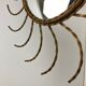 Mid century gold sunburst mirror with convex glass.