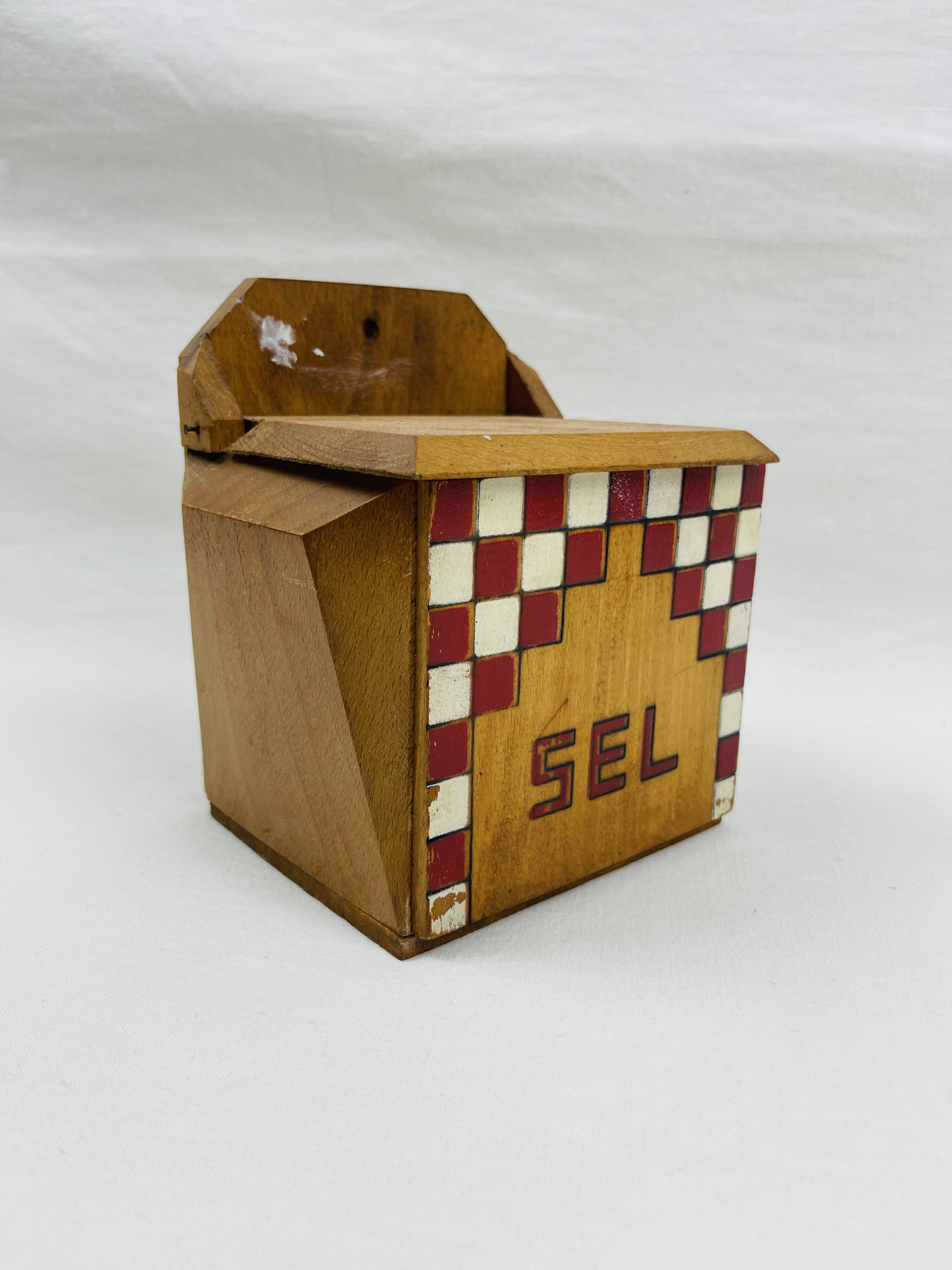 Old wooden salt box with red and white checkerboard decoration