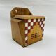 Old wooden salt box with red and white checkerboard decoration