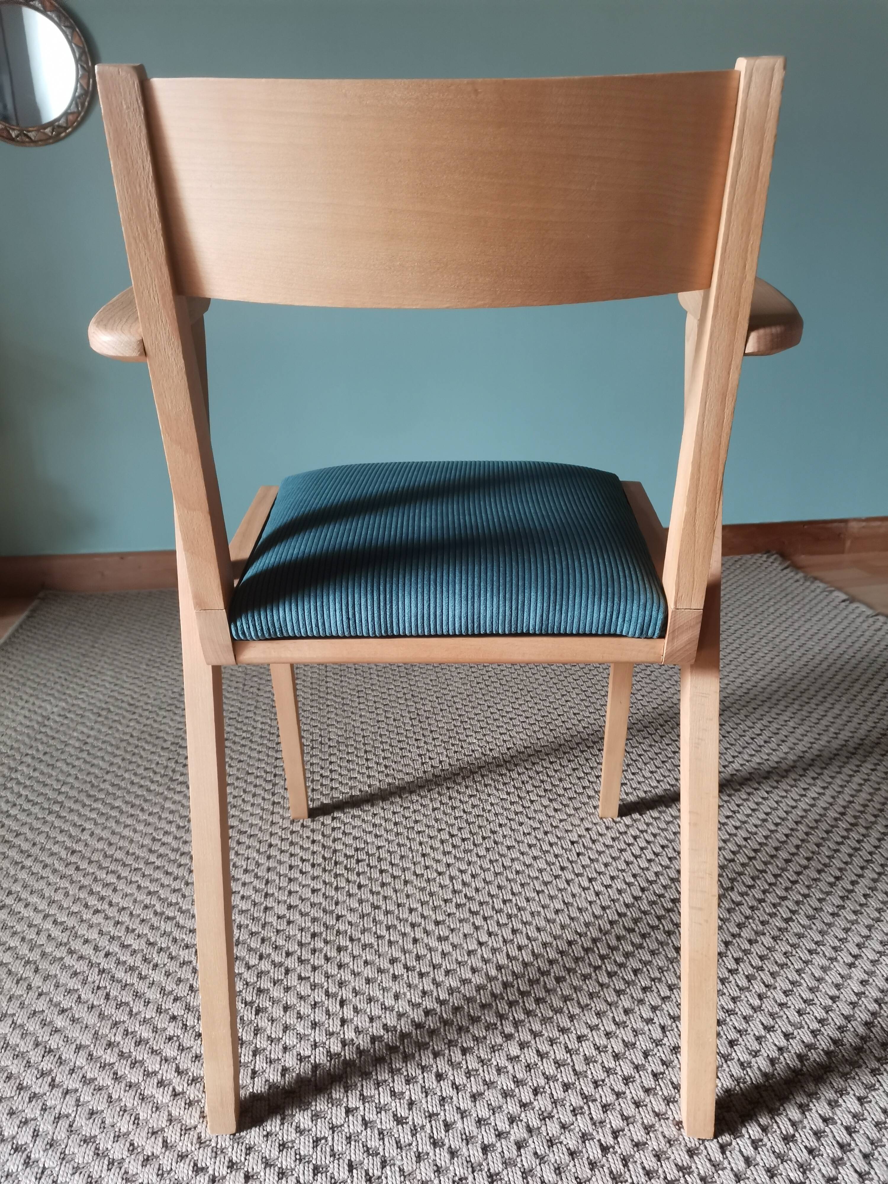 Scandinavian armchairs with green tapered legs.