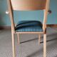 Scandinavian armchairs with green tapered legs.