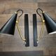 Pair of modernist sconces in black and gold metal