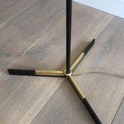 Designer floor lamp in black lacquered metal and brass