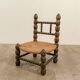 Low chair in beaded wood and straw