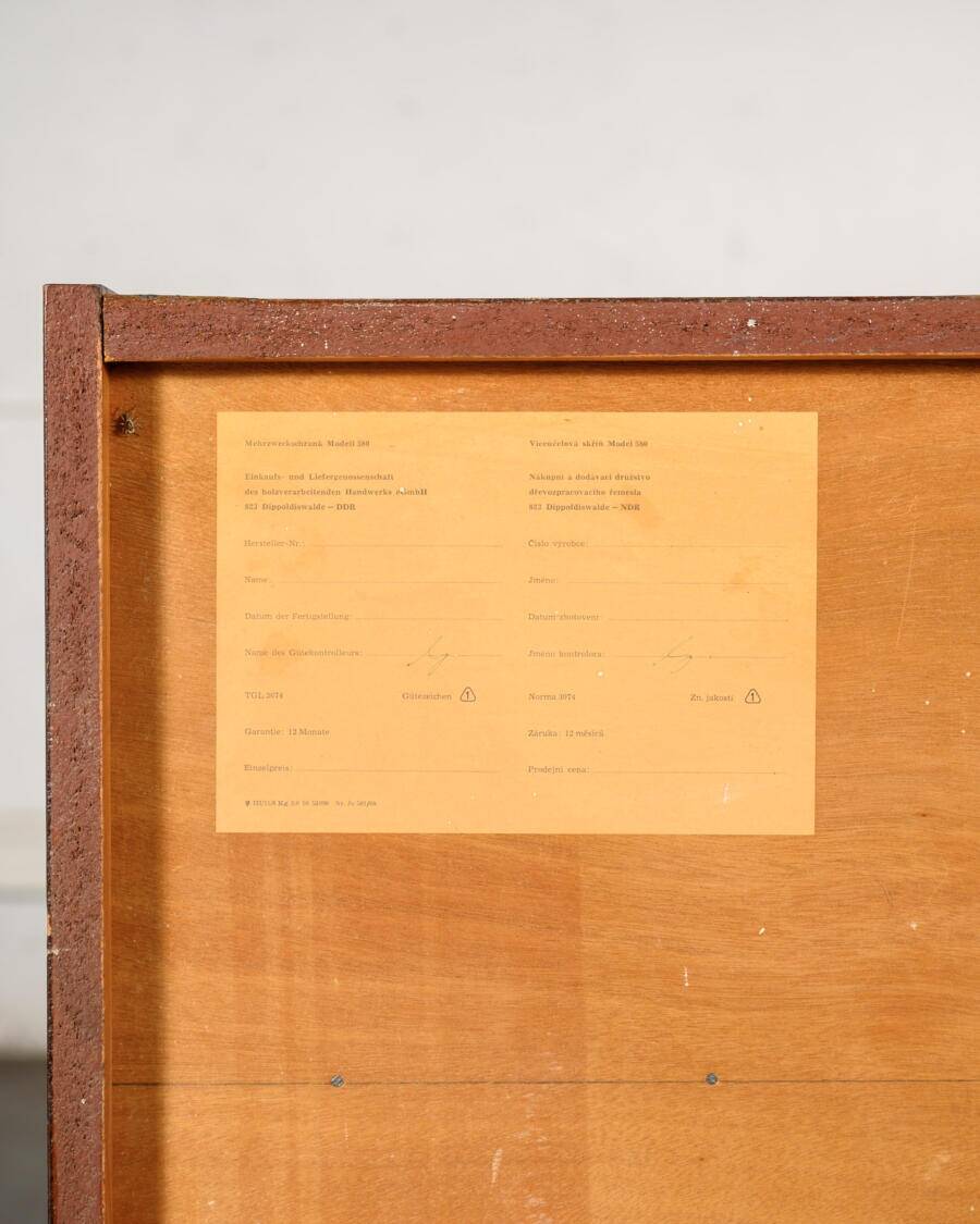 Old TV cabinet with brass handles.