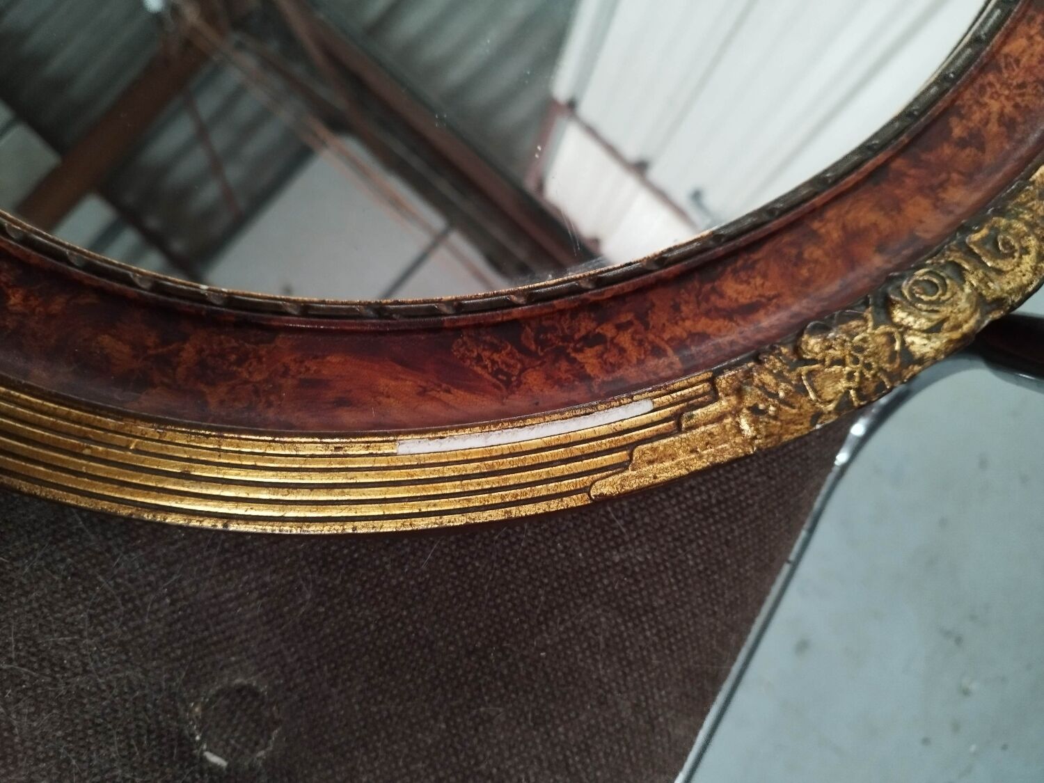 Golden oval art deco mirror