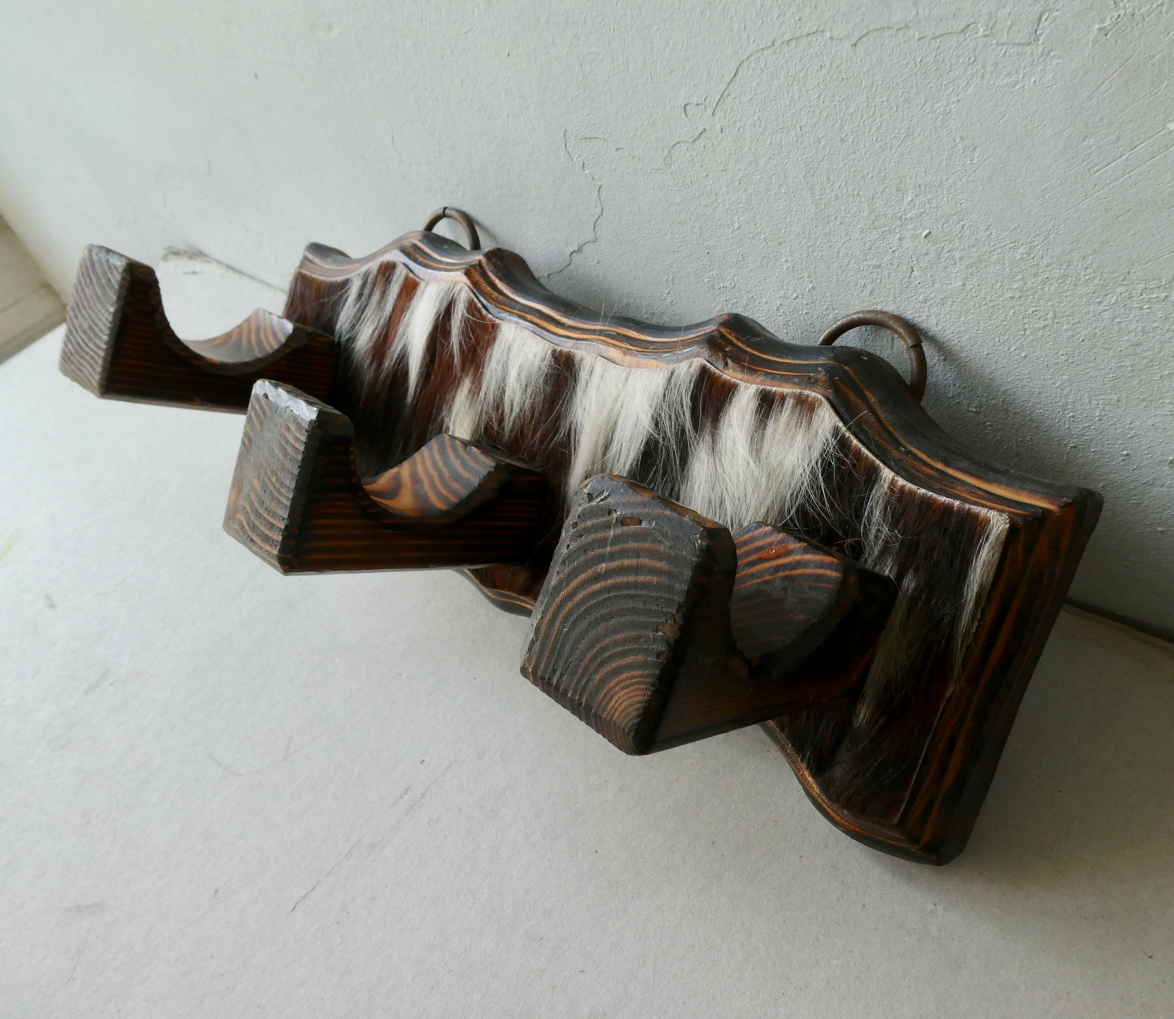 Wall hanger in burnt pine and cow skin