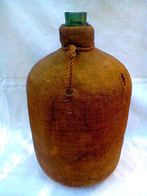 Demijohn dressed in burlap and padded cork