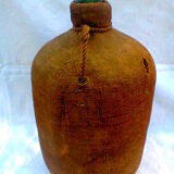 Demijohn dressed in burlap and padded cork