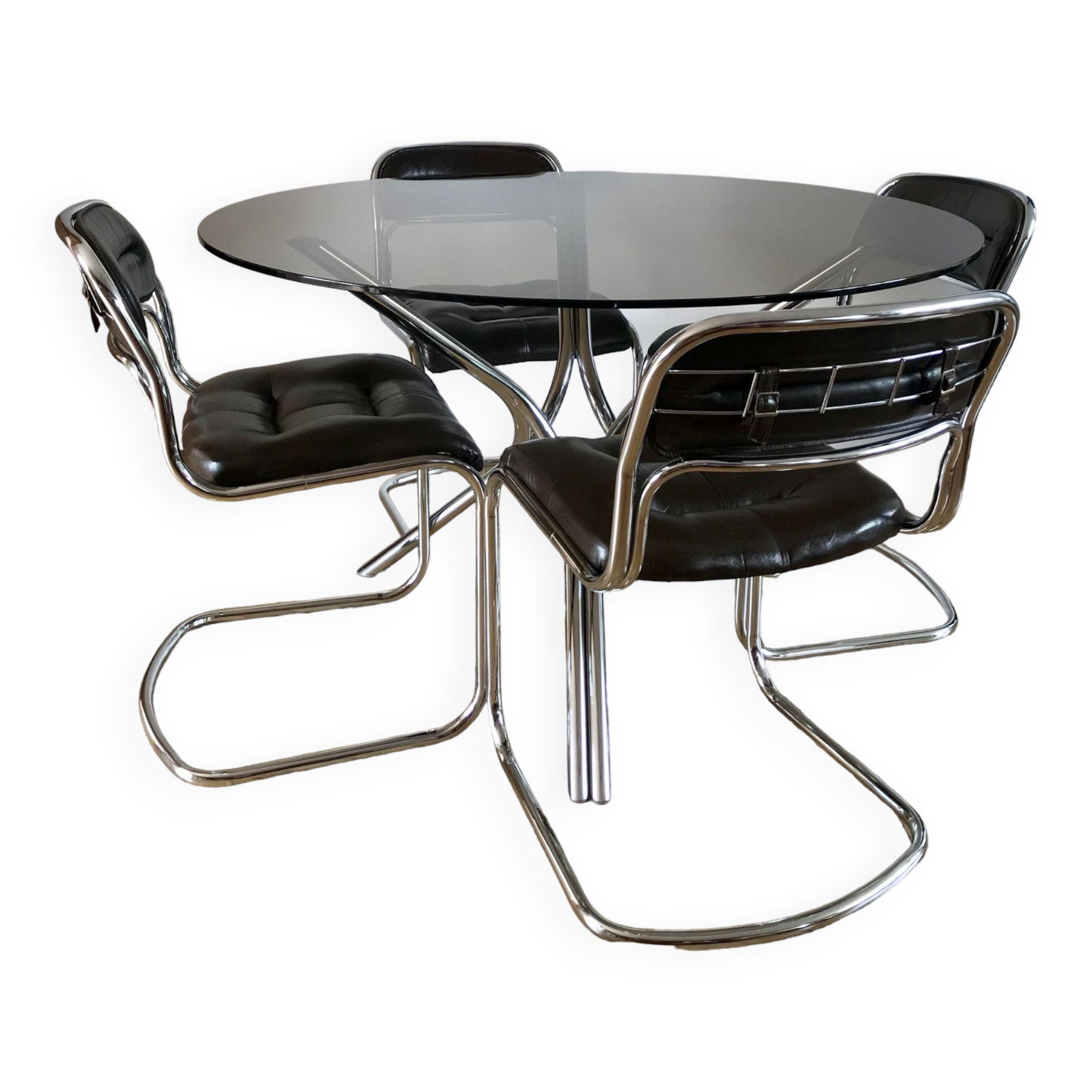 Set consisting of a table in chrome and smoked glass and its 4 tubular chairs in chrome and skaï a