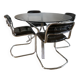 Set consisting of a table in chrome and smoked glass and its 4 tubular chairs in chrome and skaï a