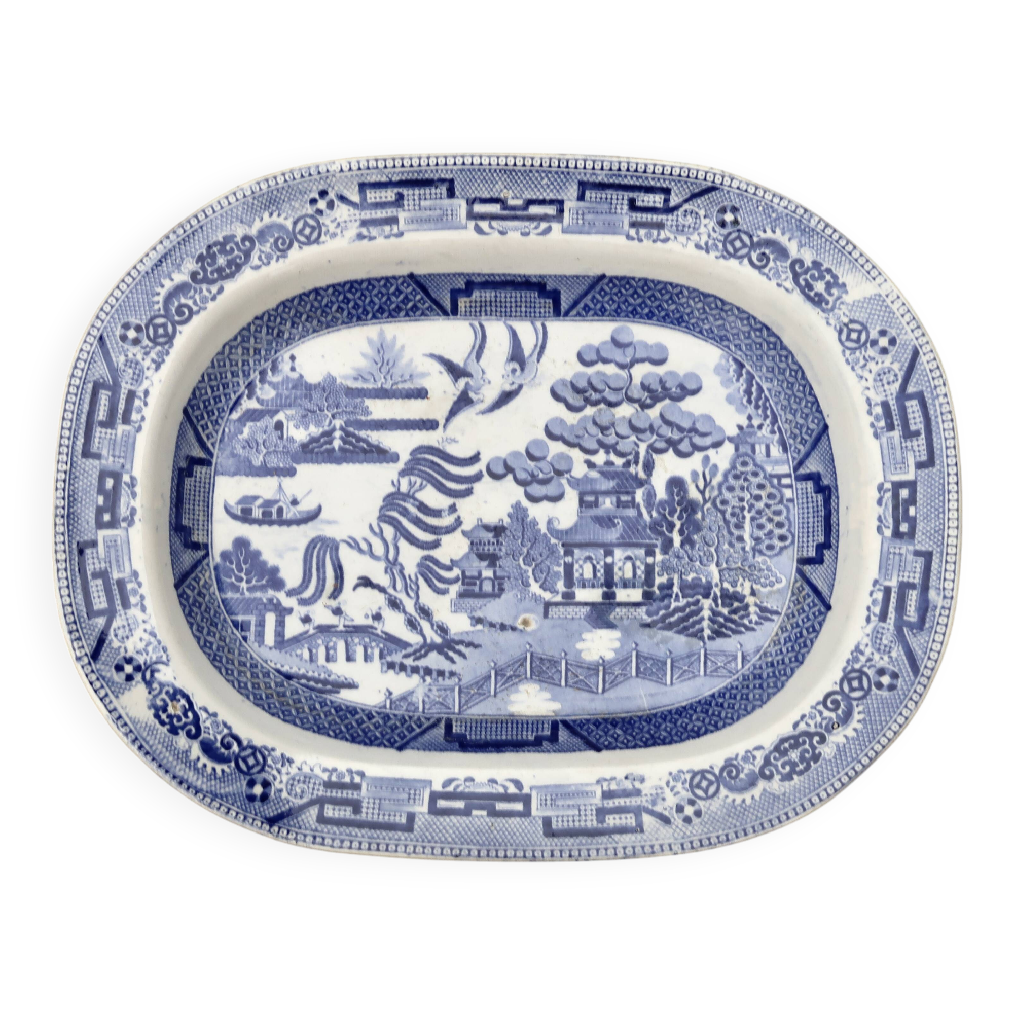 Large oval dish in blue and white English earthenware with Asian decoration, 19th century.