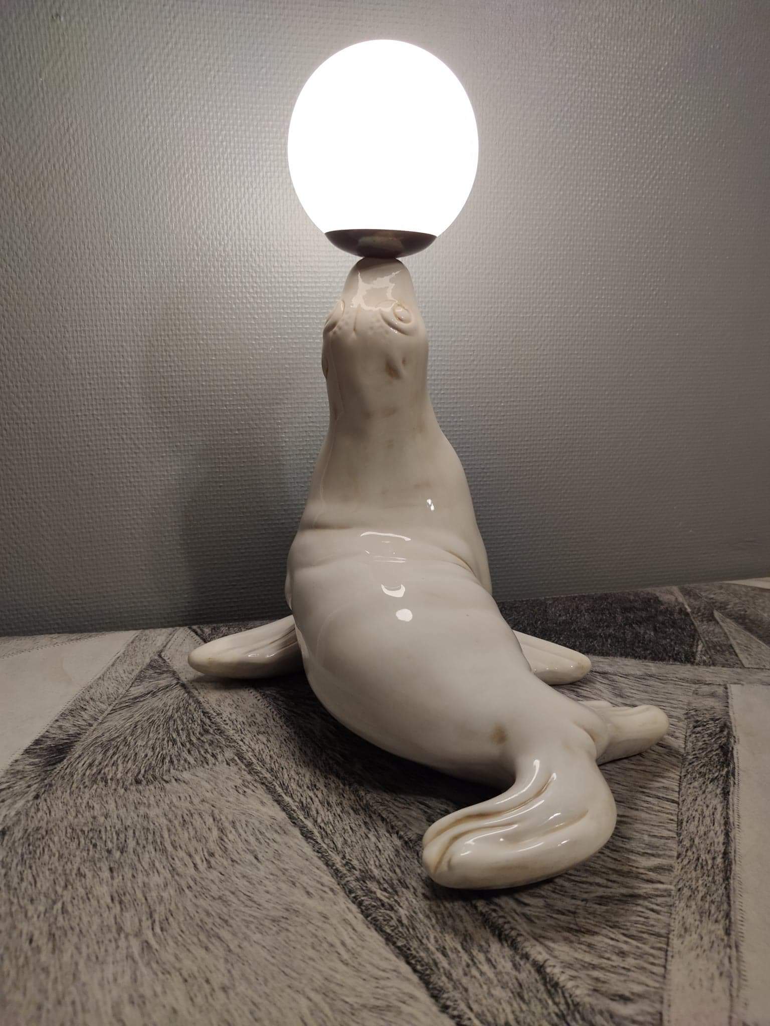 White ceramic sea lion lamp and opaline globe