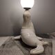 White ceramic sea lion lamp and opaline globe