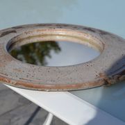 Miroir rond en céramique signé