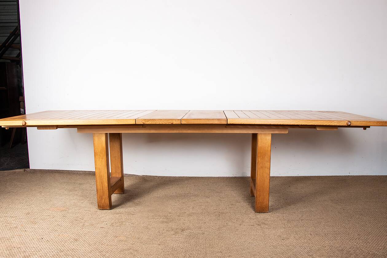 Large extendable dining table in solid oak by Guillerme and Chambron.