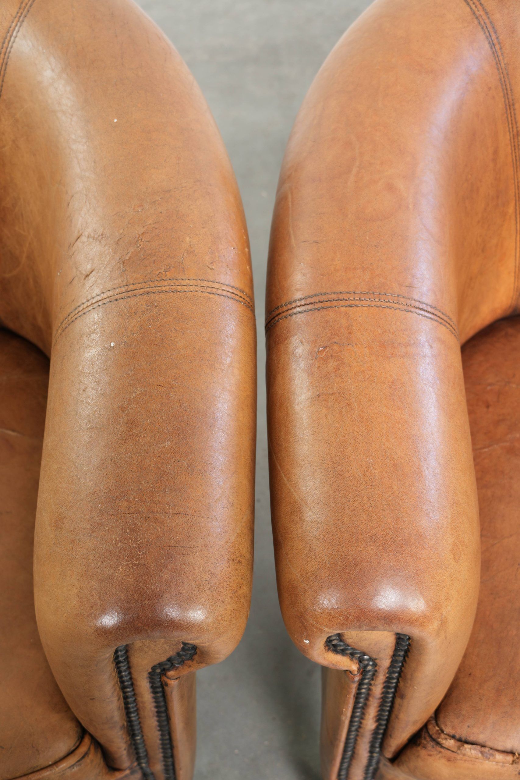 Set of two vintage sheepskin club armchairs with a beautiful light colour