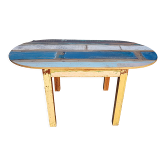 Oval table in polychrome wood