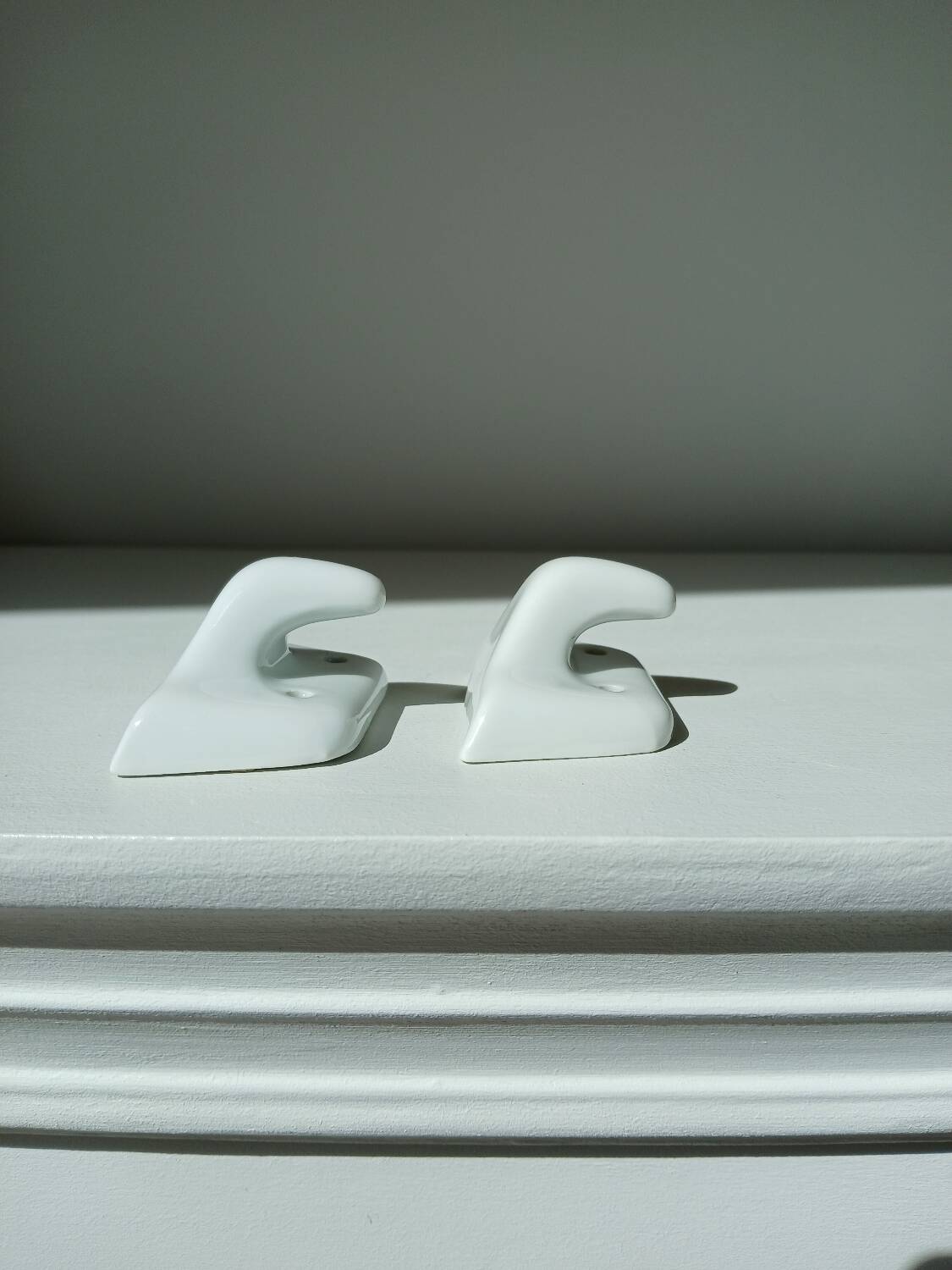 Set of two porcelain tea towel holders