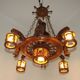 French vintage Breton chandelier with hand-carved figures, well, and lantern lights.