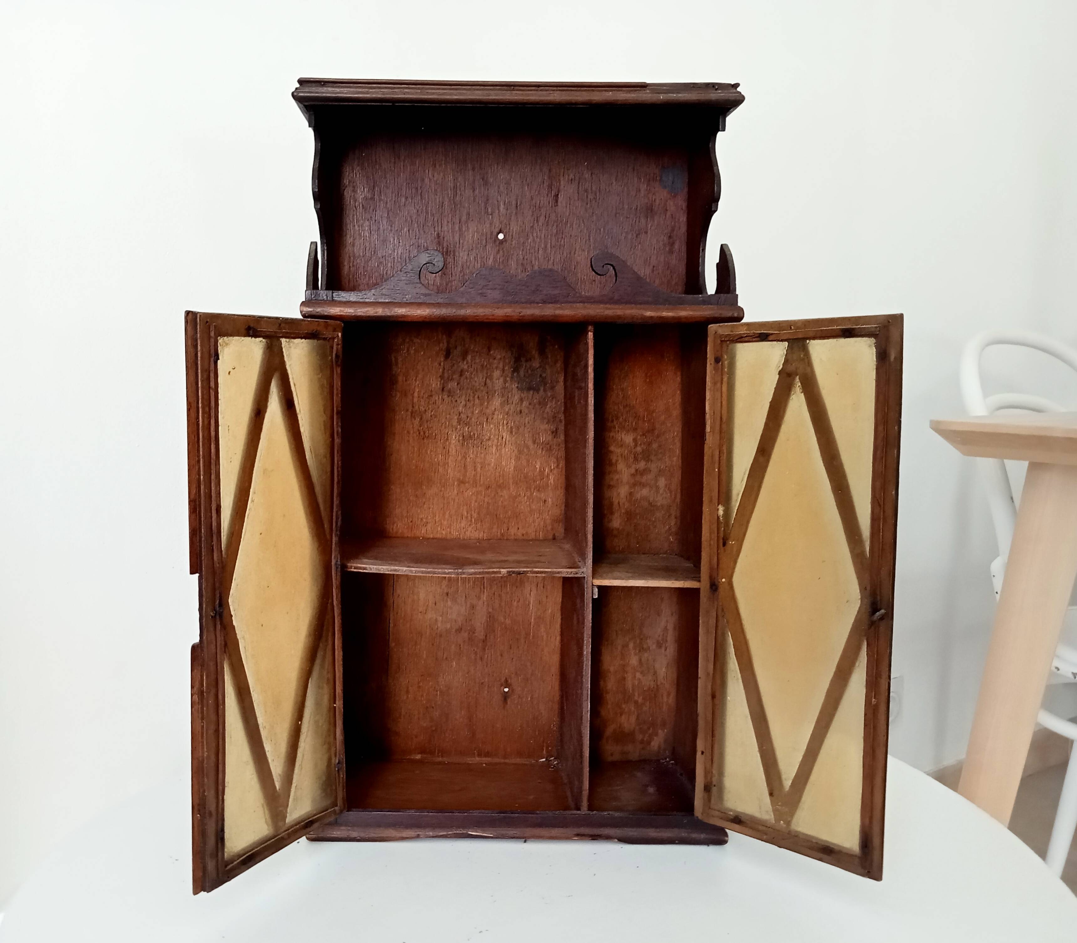 Small antique wall cabinet in Gothic style.