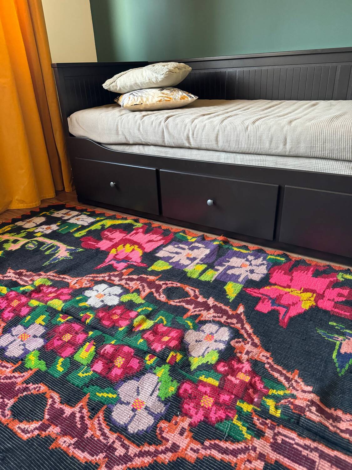 Bohemian floral design, handwoven wool rug, black background with colorful flowers