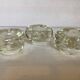Set of three thick moulded glass candle holders.