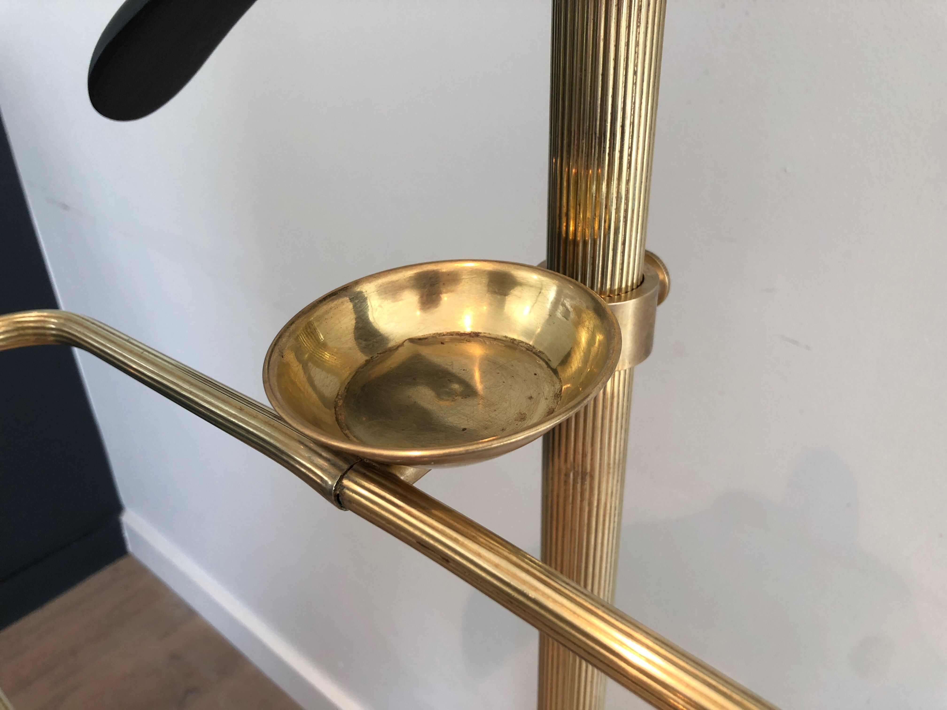 Neoclassical style valet stand in brass and black lacquered wood. French work. Circa 1940