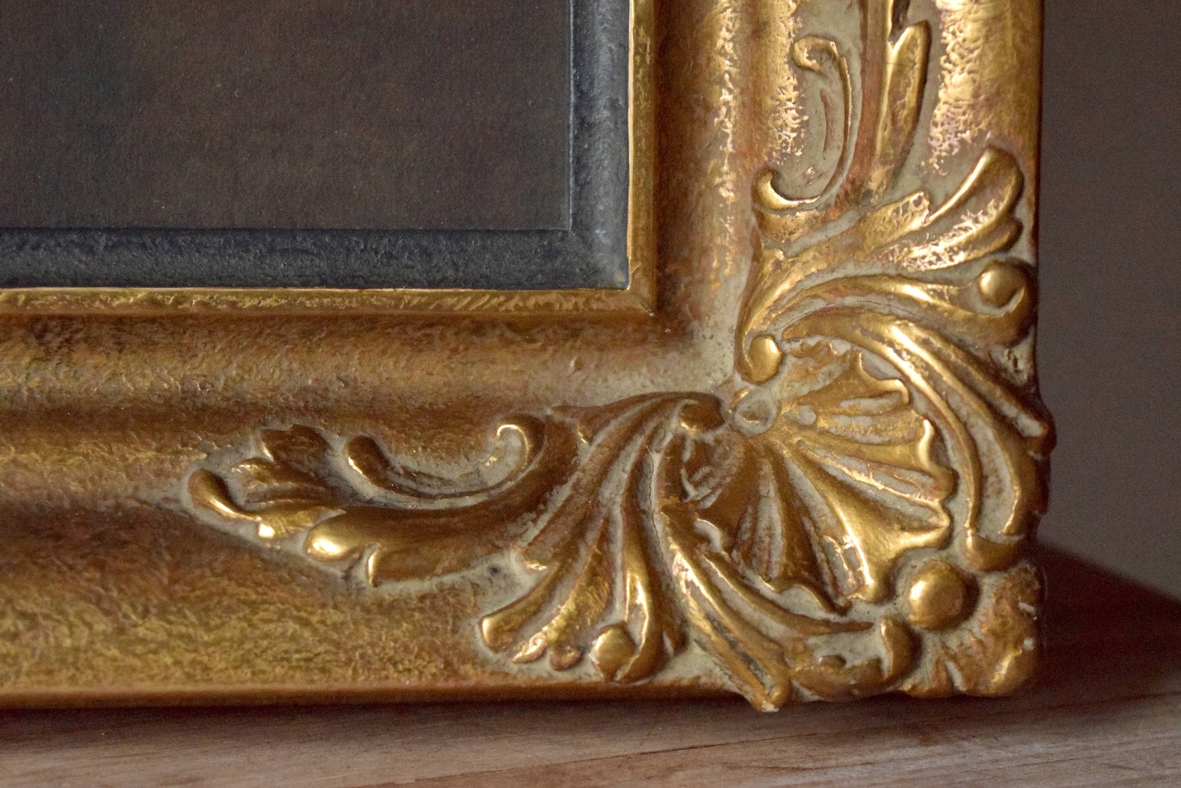 Old large wall frame in gilded carved wood