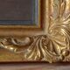 Old large wall frame in gilded carved wood