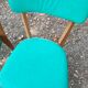 Set of 4 vintage chairs in wood and imitation blue leather dating from the 50s. Wooden structure. Seat and backrest in imitation leather 2 mint green and 2 yellow. Seating dimension: 46 cm. Good state of conservation, some traces of wear.