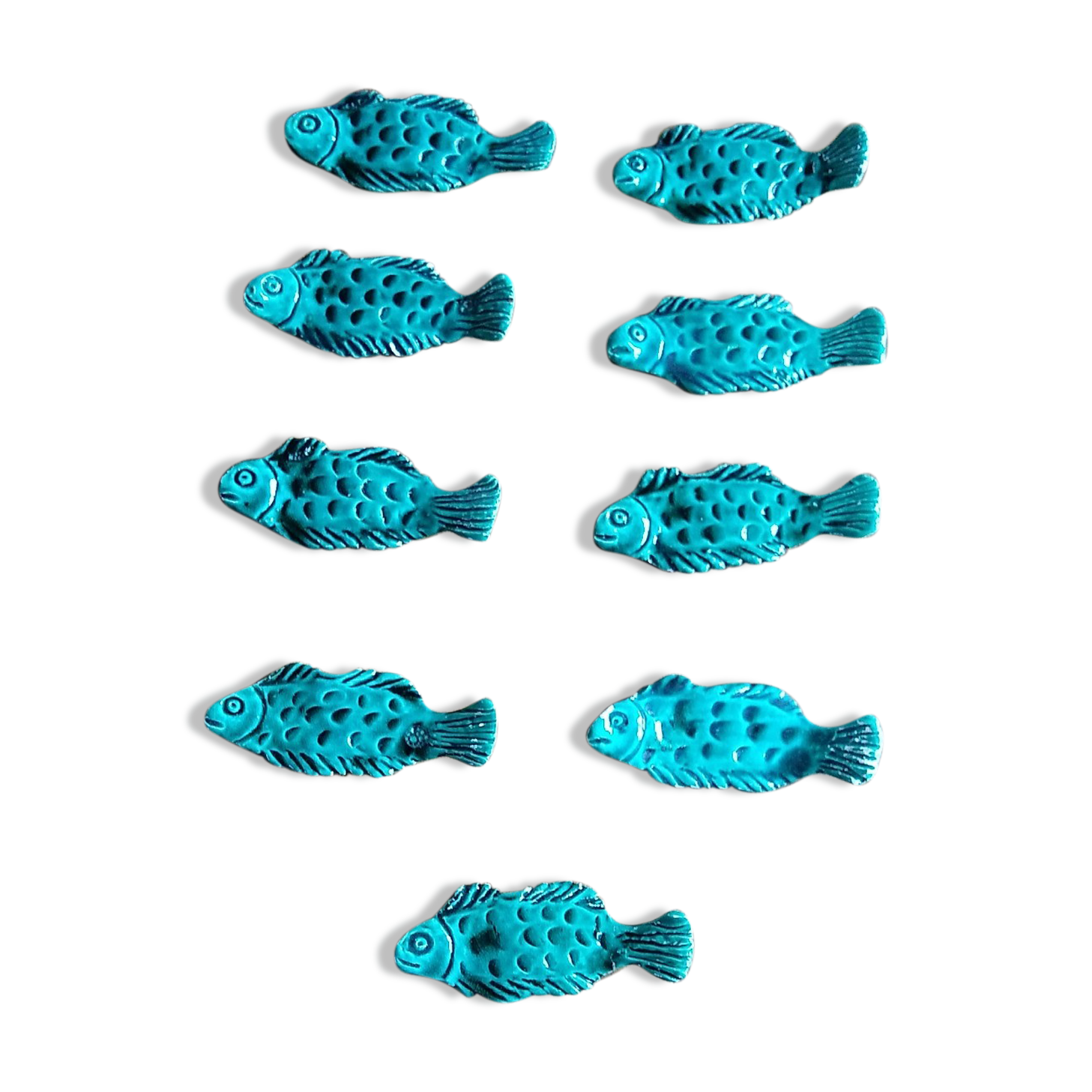 9 knife holders in green earthenware in the shape of a fish