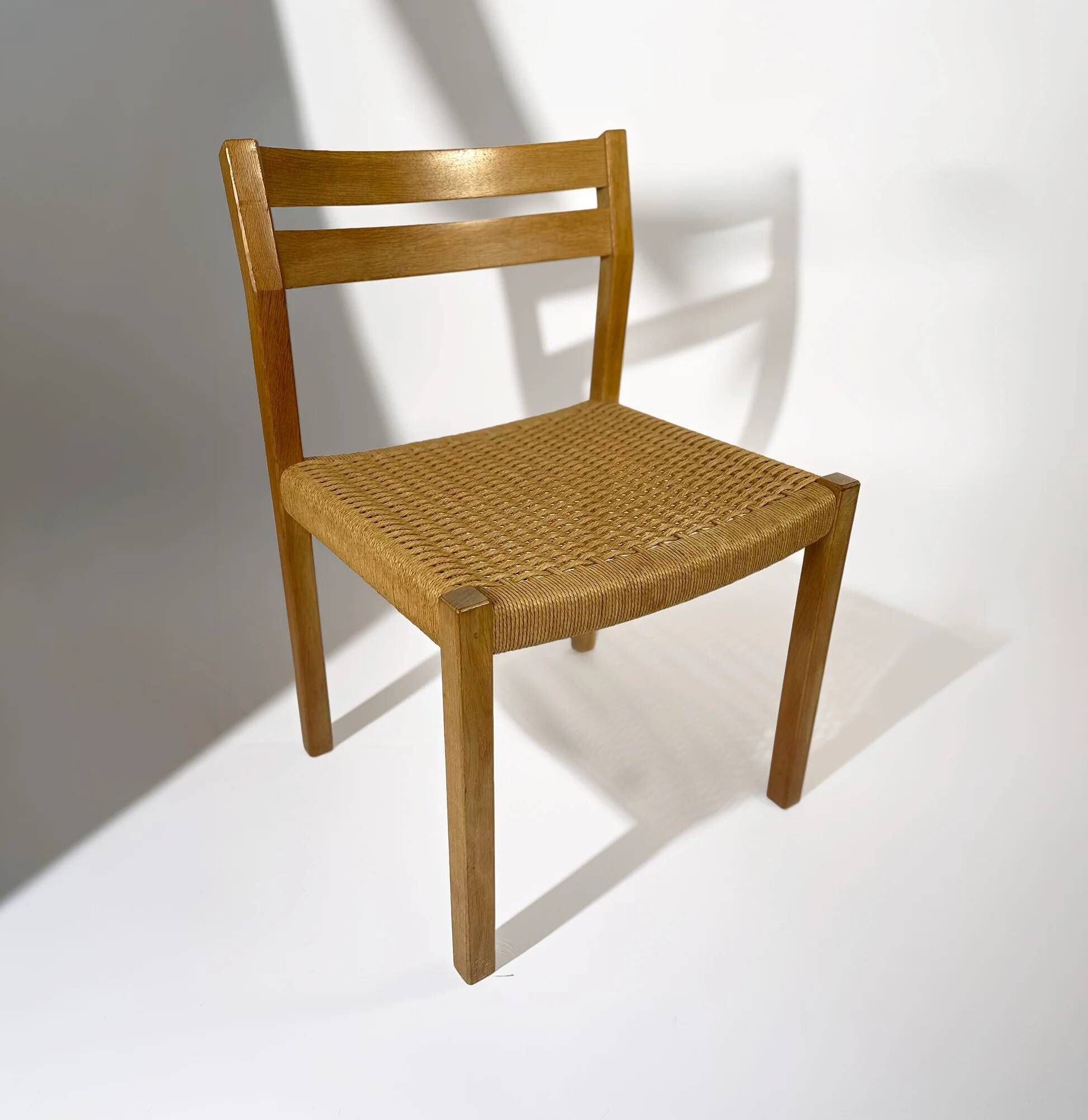 Dining chairs J.H. Møller model 401 in oak with original Danish cord — Denmark, 1970s
