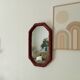 Vintage octagonal mirror in woven rattan.