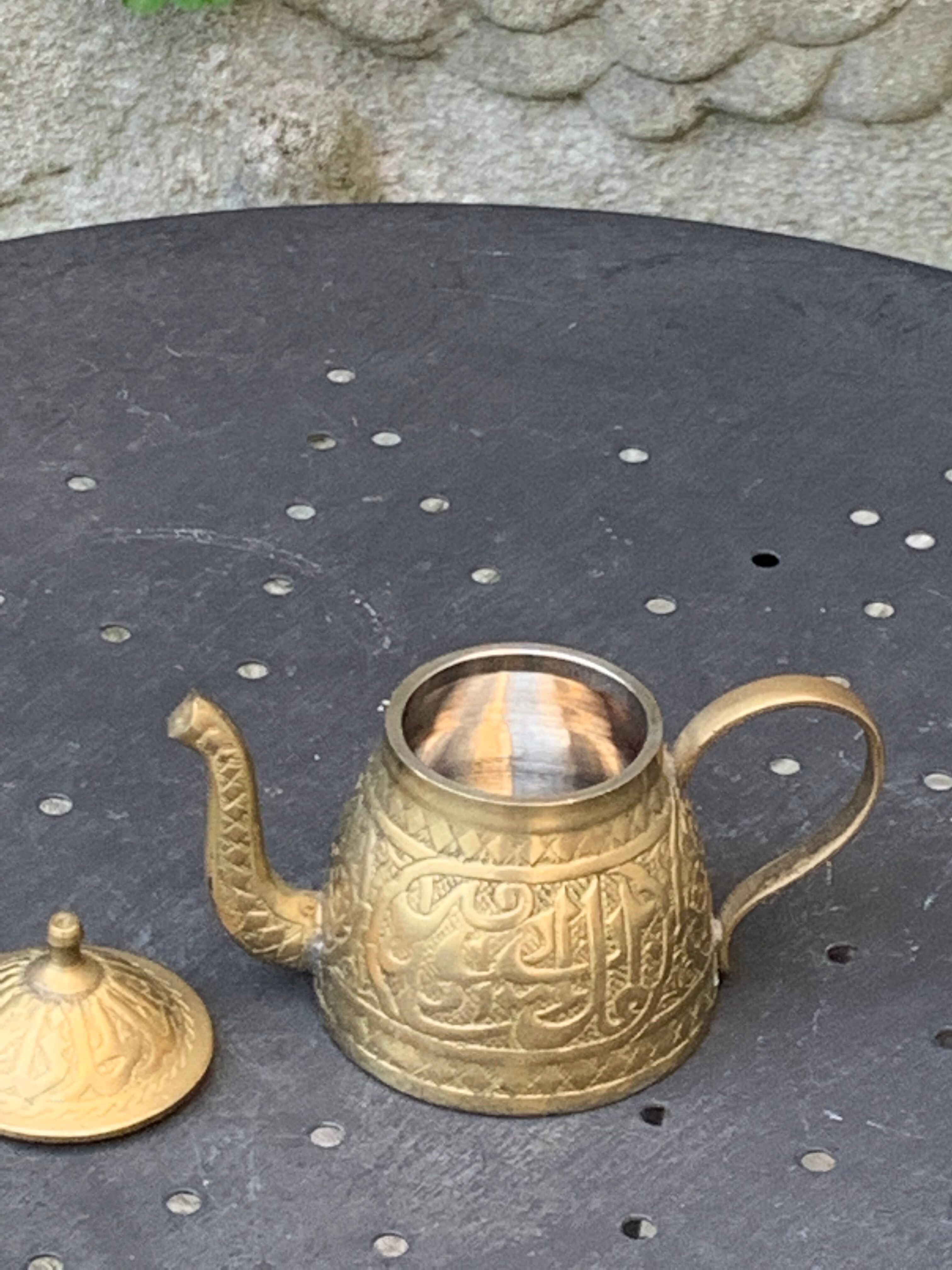 Small decorative teapot in vintage chiseled copper