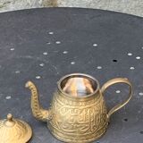 Small decorative teapot in vintage chiseled copper
