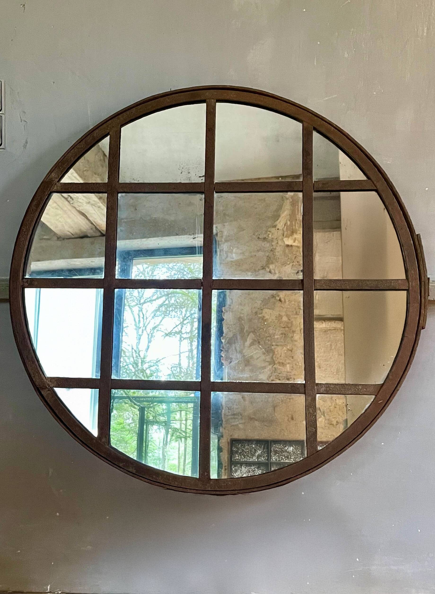 Round mirror mounted in mild steel