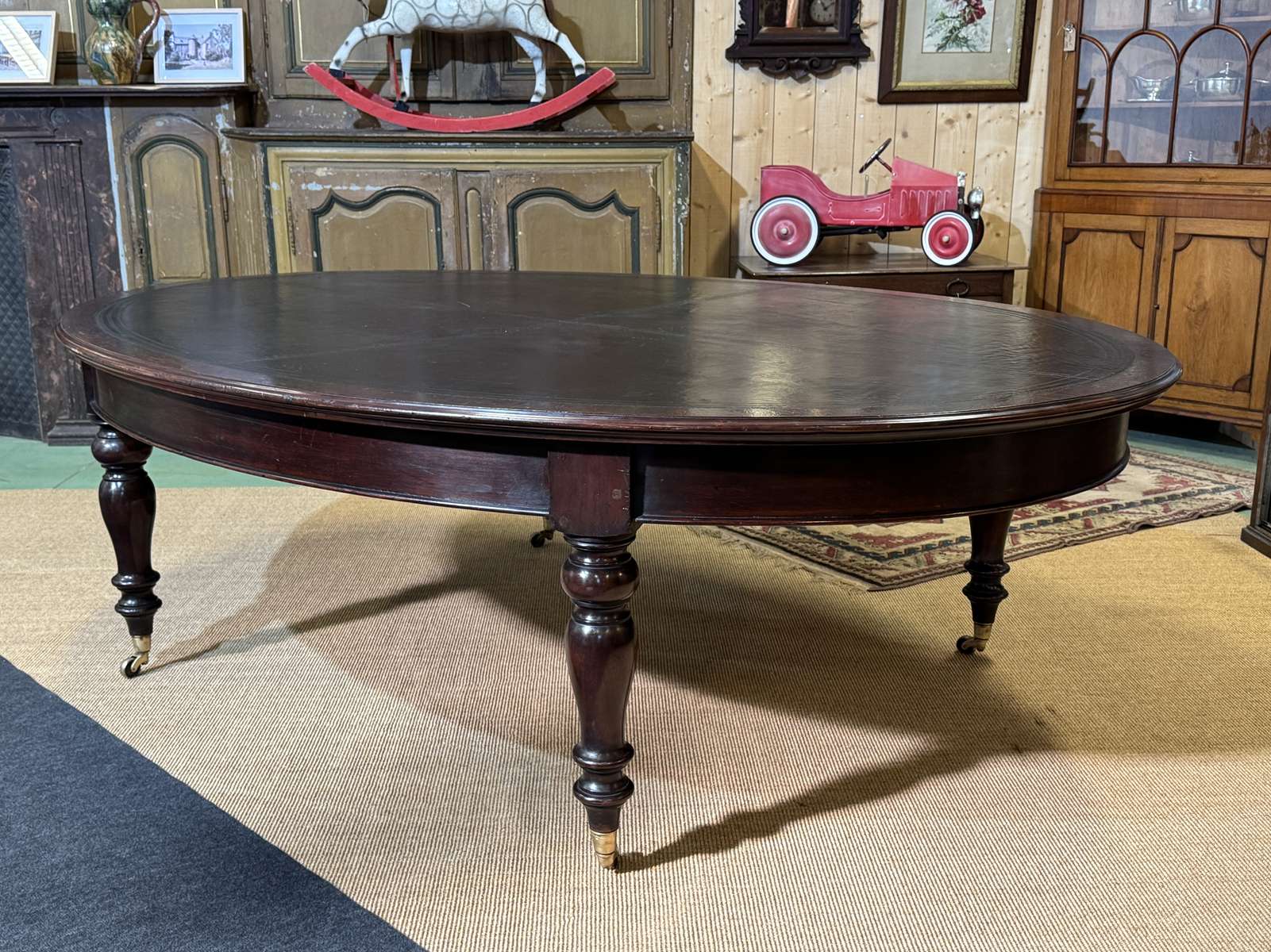 Large English library table in dark walnut with a leather top.