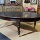 Large English library table in dark walnut with a leather top.