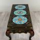 Black lacquered wooden coffee table with cloisonné and polychrome decoration, 20th century.