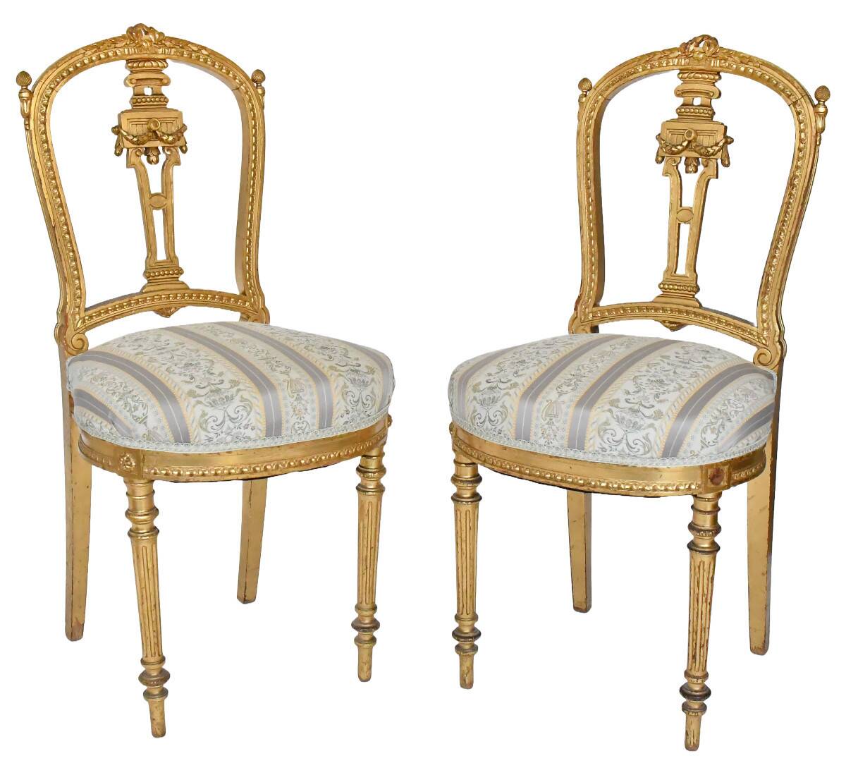 Pair of Louis XVI style chairs in gilded wood.