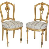 Pair of Louis XVI style chairs in gilded wood.
