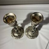 Two silver-plated metal candlesticks decorated with cherubs, 20th century