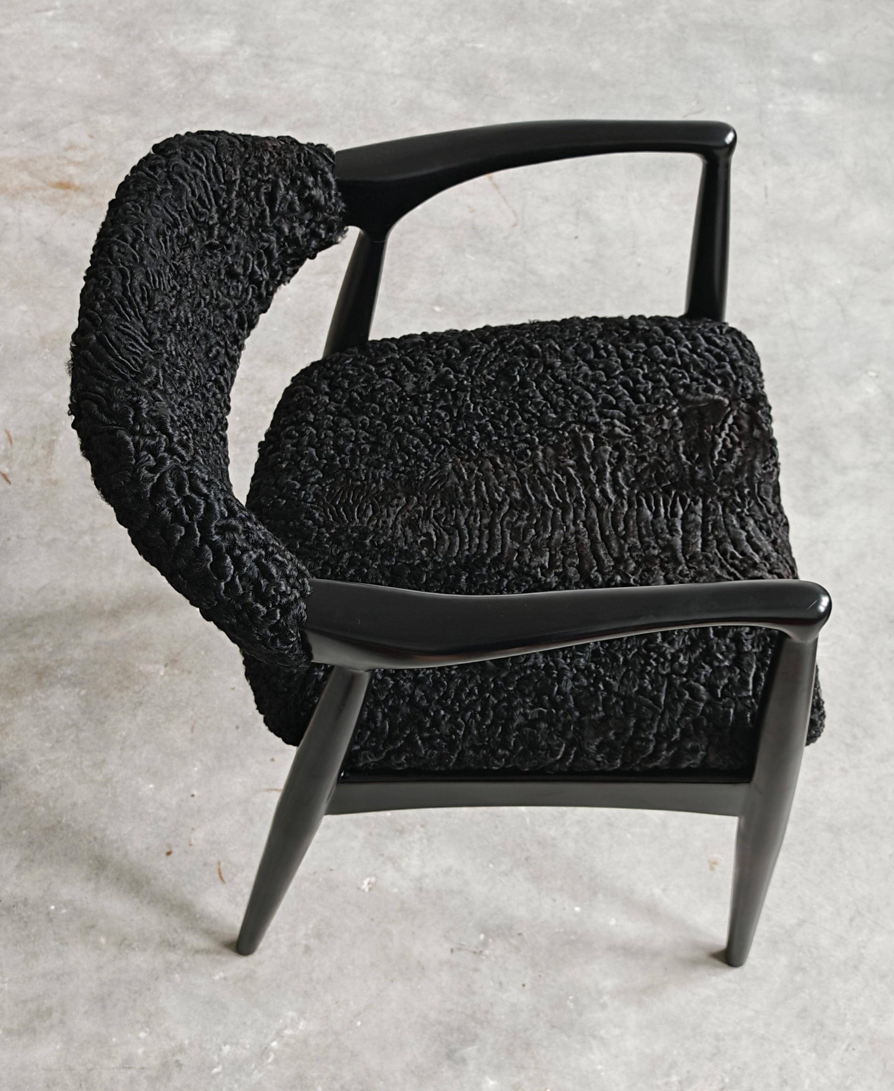 Pair of Mid Century Modern armchairs in astrakhan leather.