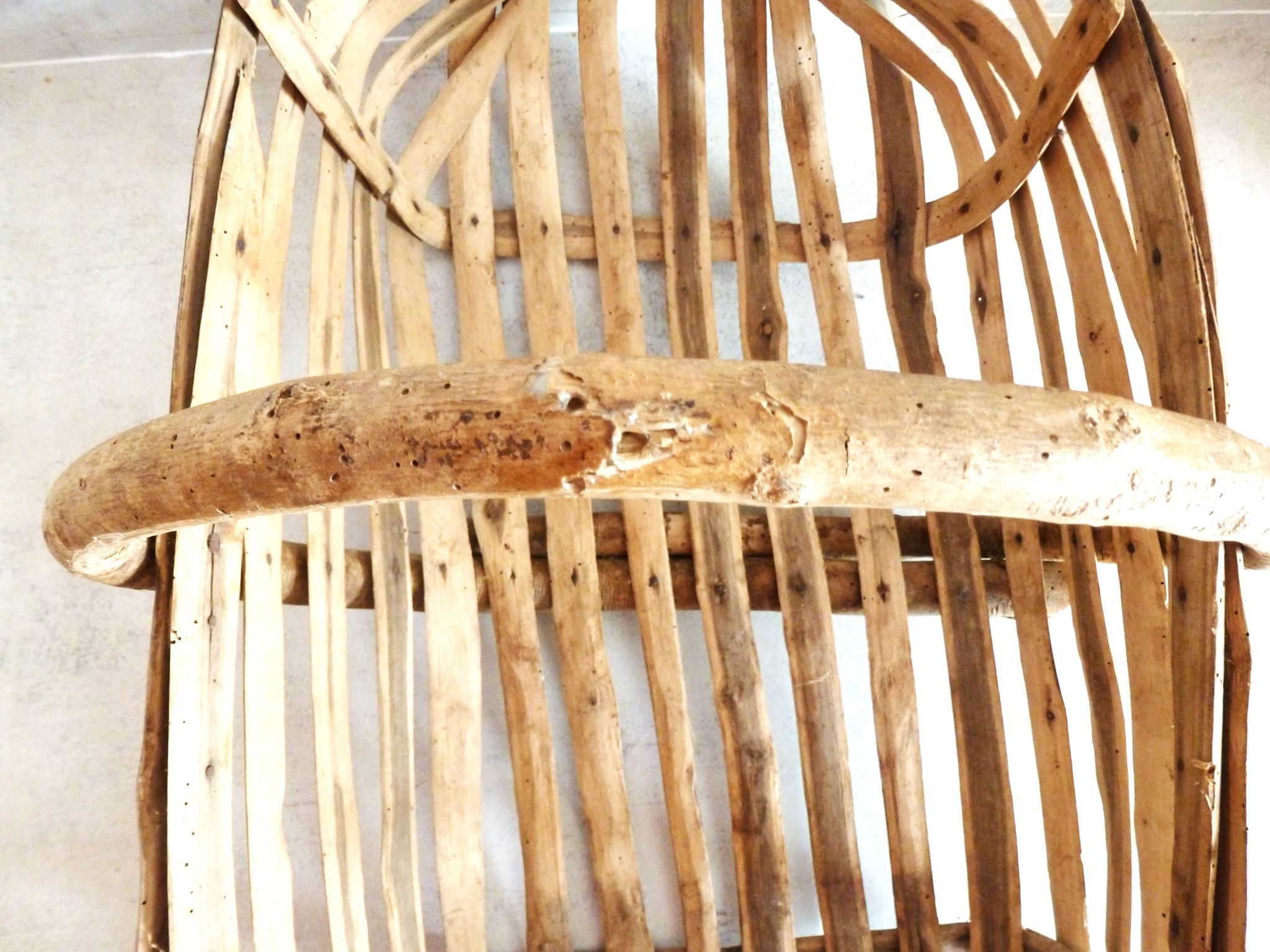 Old wooden harvest basket, slatted wooden basket, folk art.