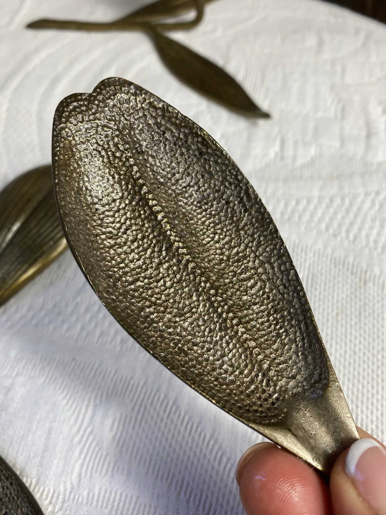 Flower candlestick and removable ashtrays in solid brass.