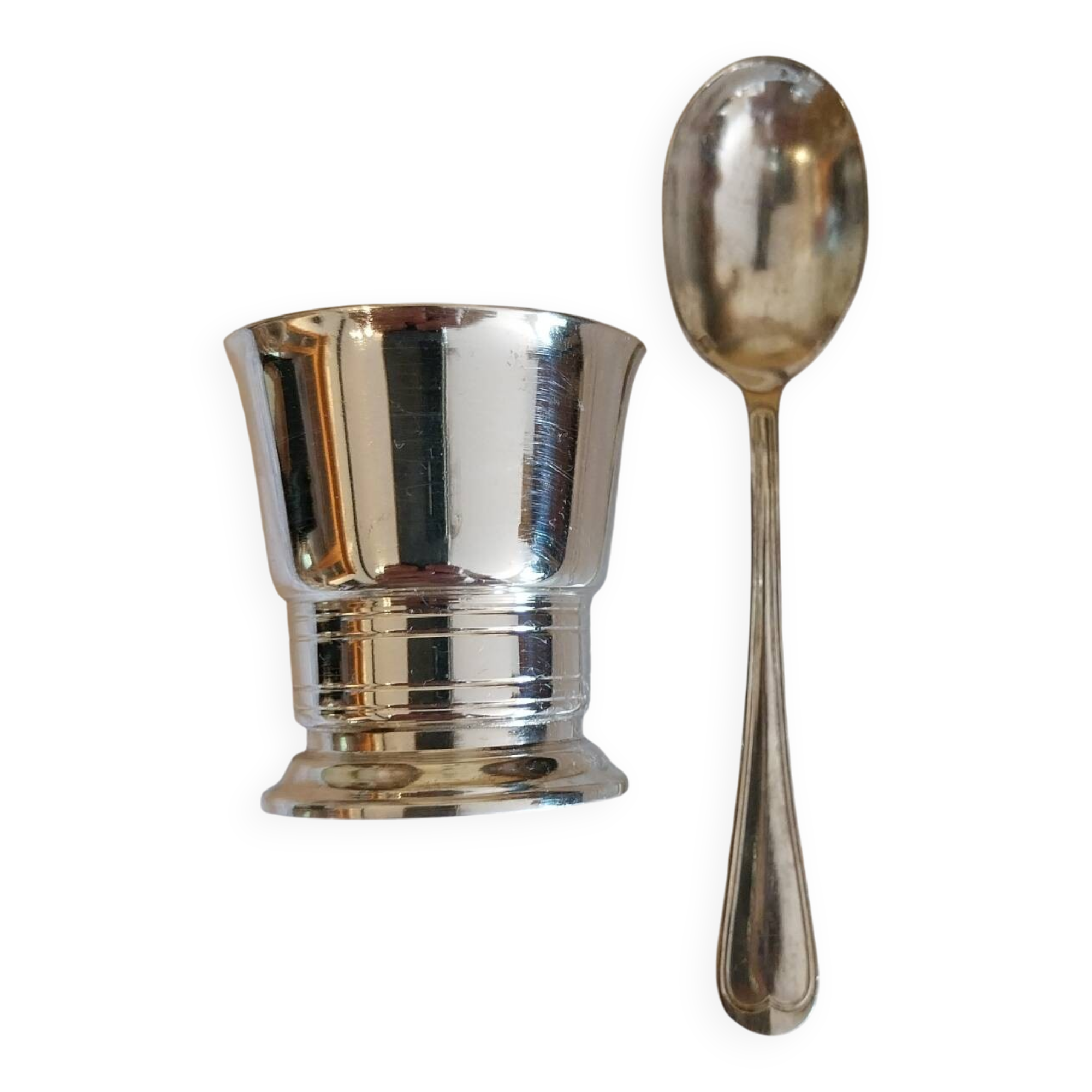 Egg cup and spoon in silver metal