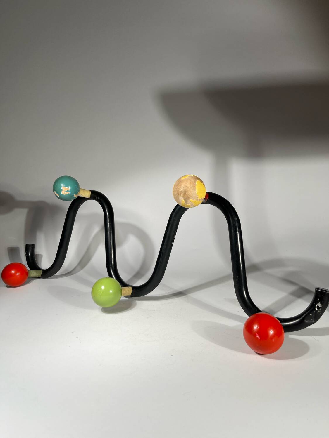 Coat rack in black lacquered metal and colored wooden balls