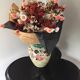 Vase in sandstone with decorations of diamonds and fruits